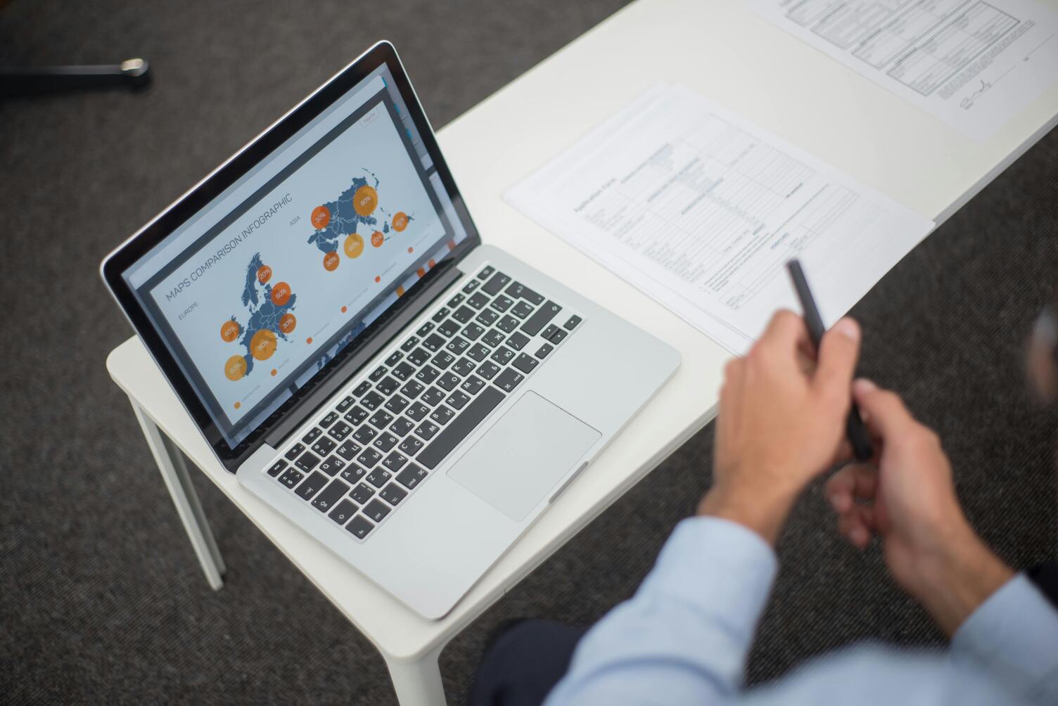 Editorial documentary photograph of a regulator-document register on a desktop monitor, calm Swiss office setting